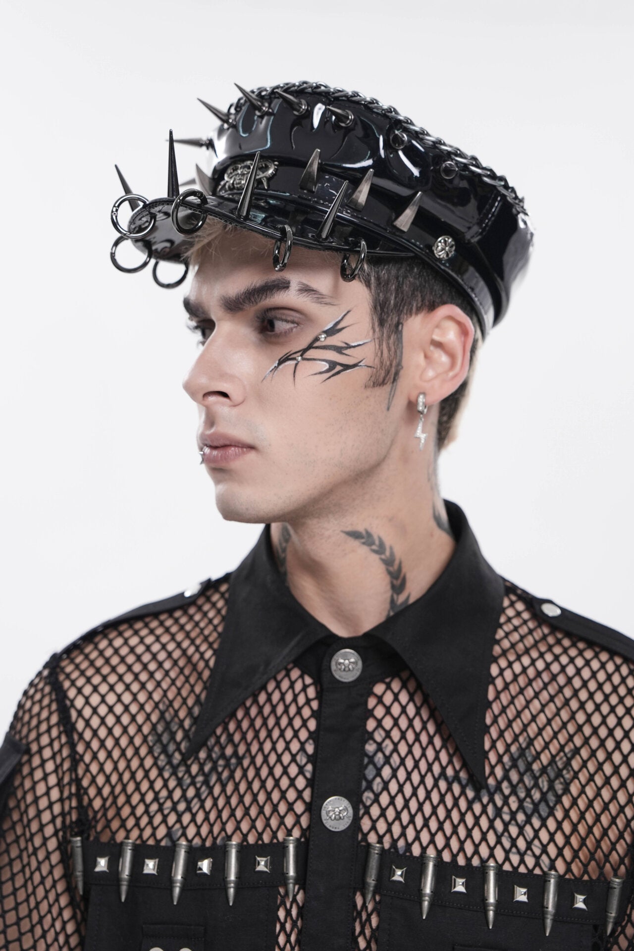 Black spiked headpiece with synthetic leather and metal details.