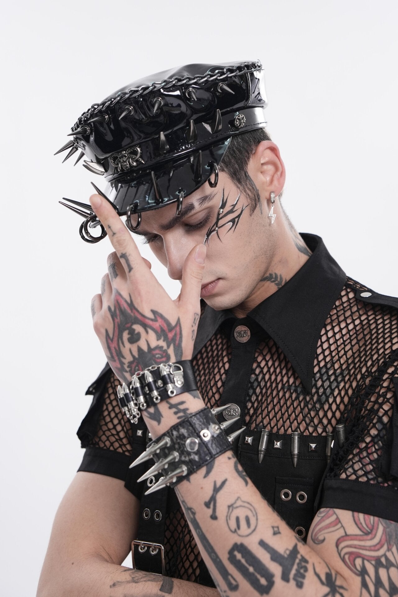 Black spiked headpiece with synthetic leather and metal details.